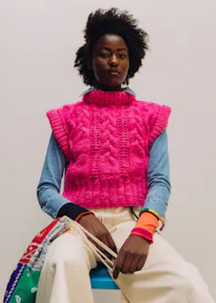 A woman in a bright pink jumper.