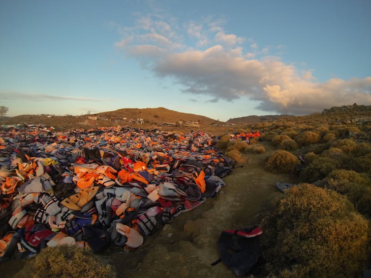 A rolling landscape covered with thousands of colorful life vests.