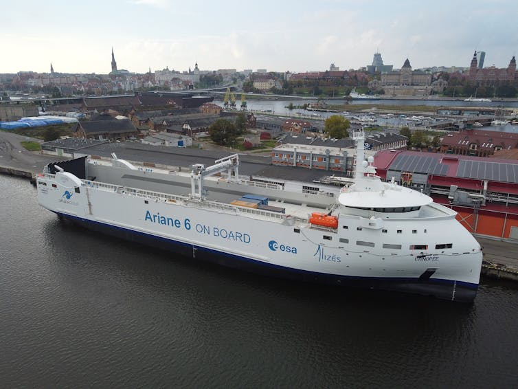 Photograph of newly launched wind-powered ship in the water at dock.