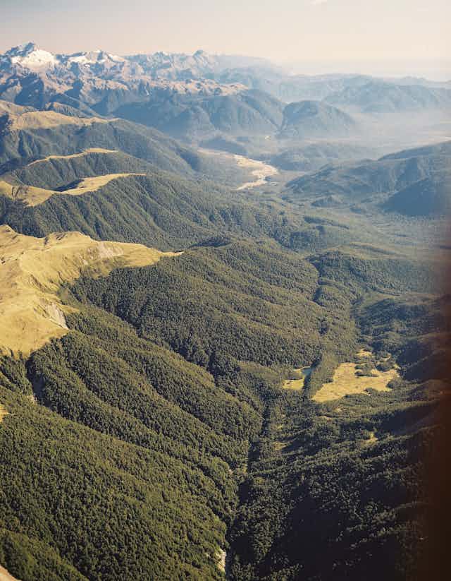 An aerial photo of a fault line running down a valley among hills.