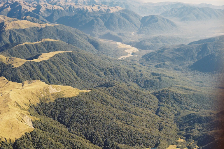 An aerial photo of a fault line running down a valley among hills.