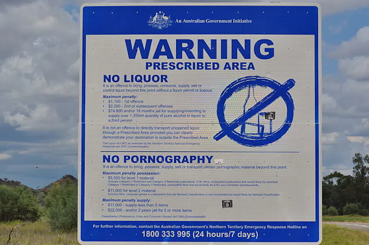 A blue and white road sign that reads