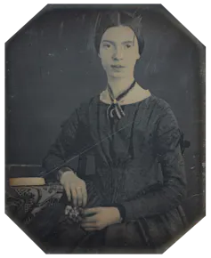 Black white photograph of Emily Dickinson, she wears her hair parted in the middle and a long sleeved black dress.