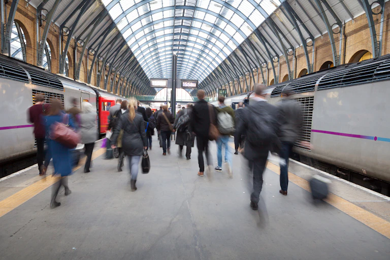 Blurred people on a train platform in a London station