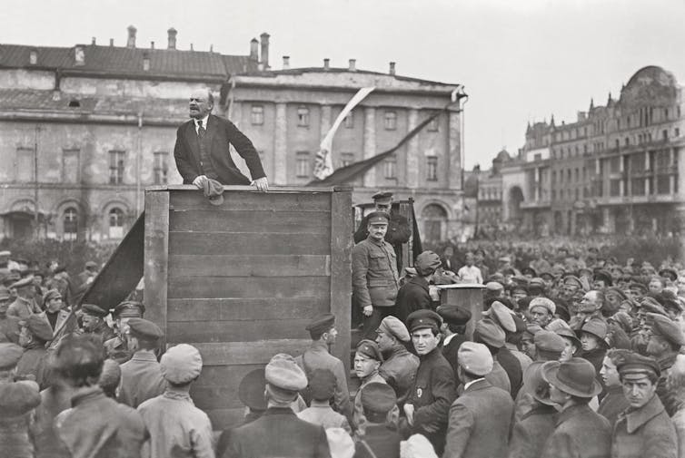 Lenin gives a speech for the Red Army in front of the Bolshoi Theater in Moscow in 1920. On the right of the picture are Lev Trotsky and Lev Kamenev.