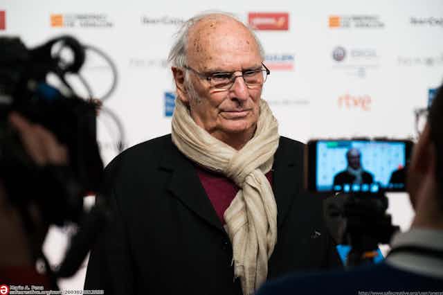 A man is interviewed on a red carpet.