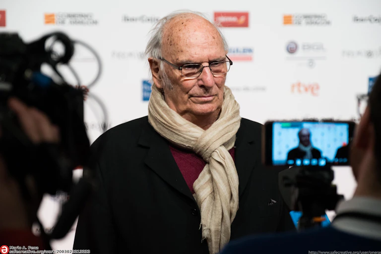 A man is interviewed on a red carpet.