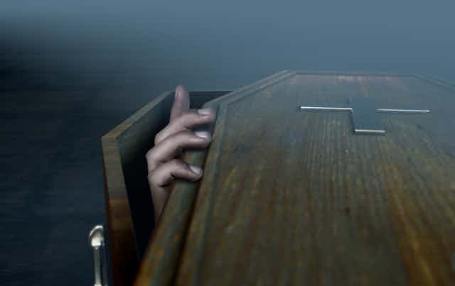 Hand coming out of a coffin