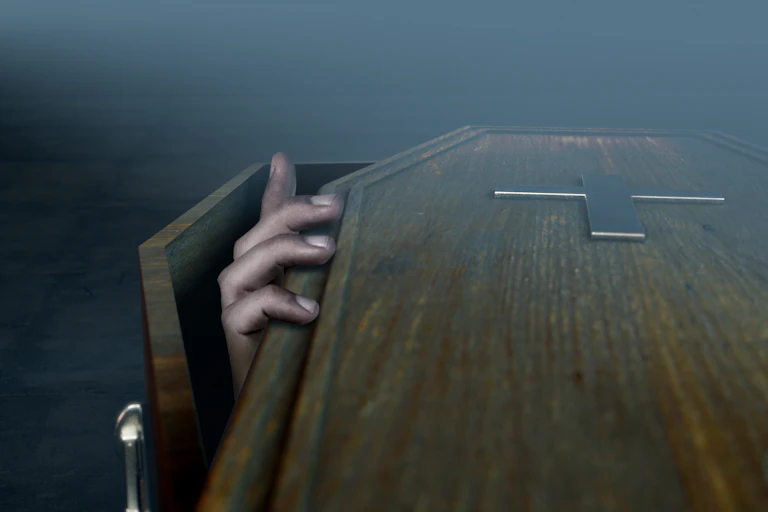 Hand coming out of a coffin