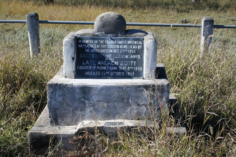 A stone memorial in a field.