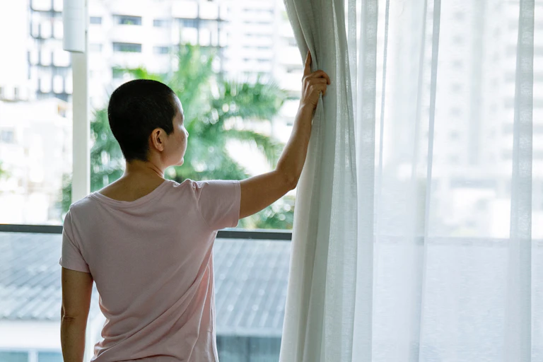A person looks out of a window.