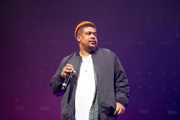 A man in beanie with a microphone.