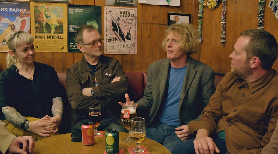 Grayson Perry sits in a typical English pub with three comedians,.