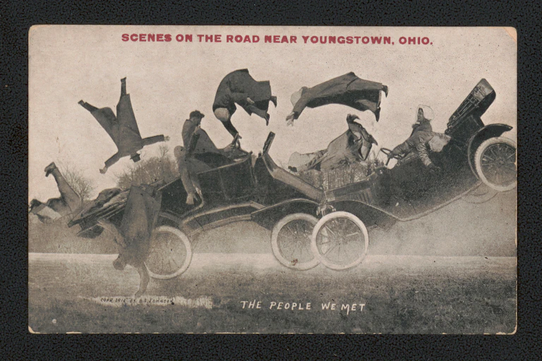 Old photo of two cars crashing and people being flung every which way.