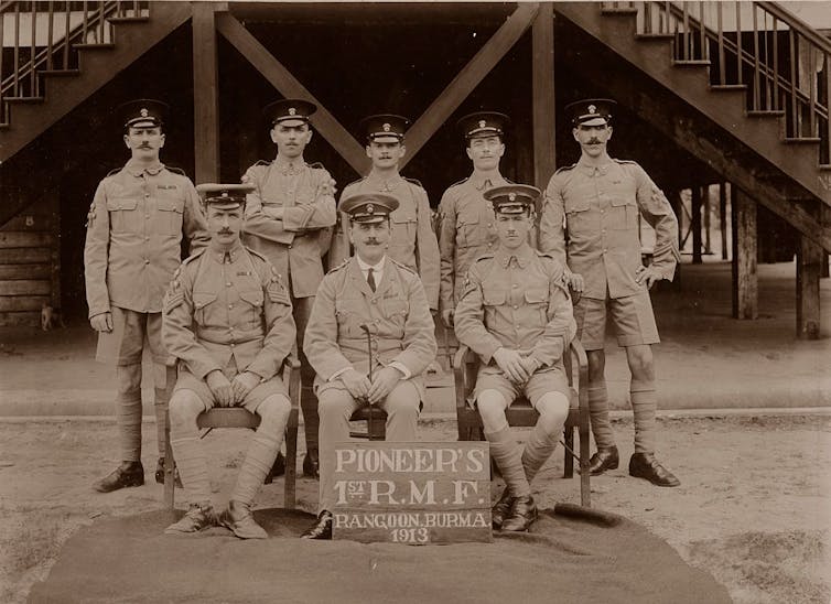 Vintage photograph of eight men in uniform.