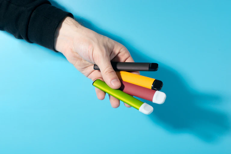 Hand holding vape pens