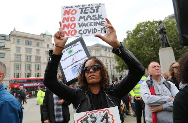 anti-vaccine protesters stage a demonstration in Trafalgar Square