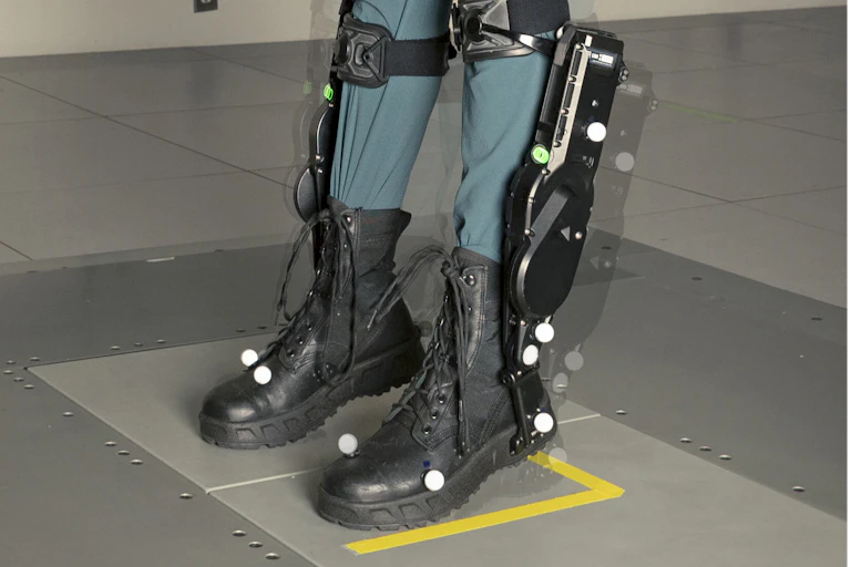 a pair of lower legs wearing a mechanical device