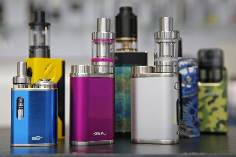 A selection of e-cigarette devices of various shapes, sizes and colours, displayed at a shop In Hong Kong.