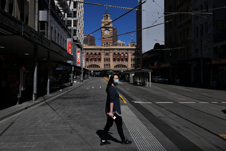 Person walking on an empty street during Melbourne's lockdown