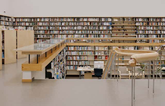 A modern library with shelves full of books.