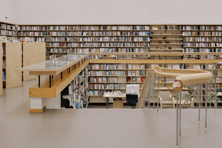 A modern library with shelves full of books.