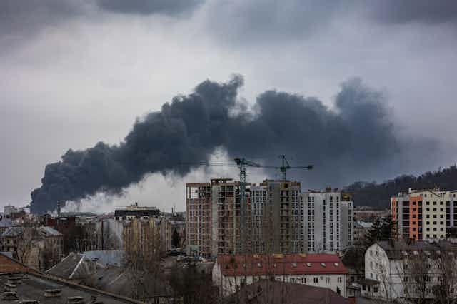 Smoke rising from bomb-damaged city