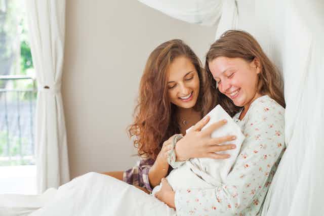 Women looking at new baby