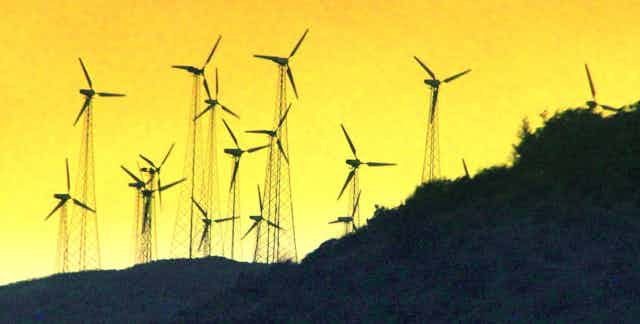 Windmills stand on a hill