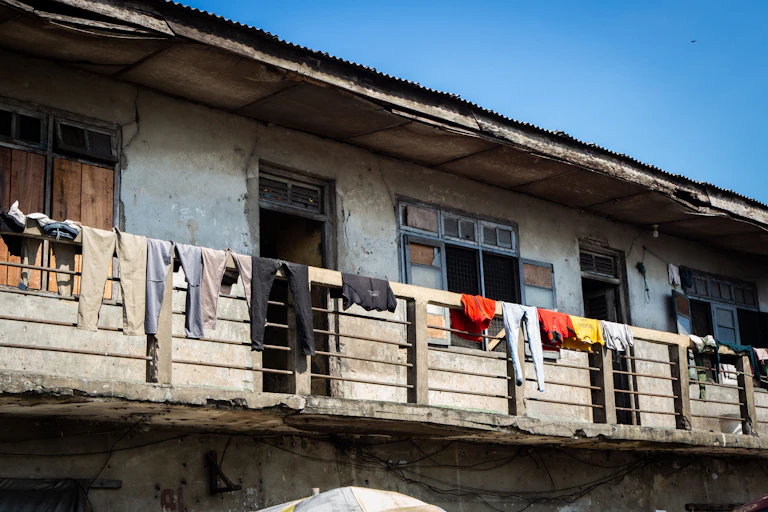 Clothes are laid out to dry in the balcony of a house