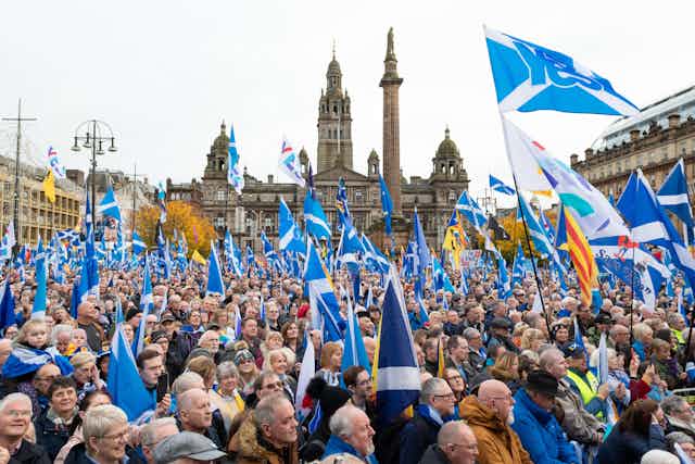A crowd of people with Scottish flags.