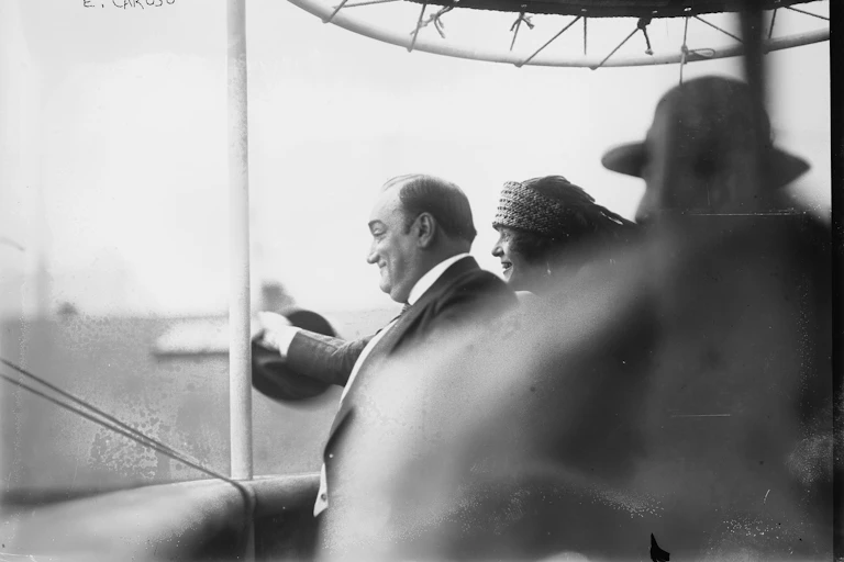 A man waves from a boat.