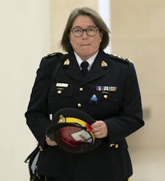 A woman wearing a police uniform