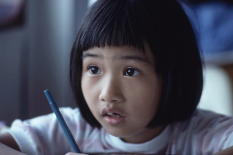Primary student holding a pencil