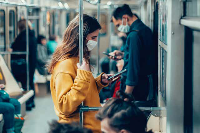 People wearing masks on a train.