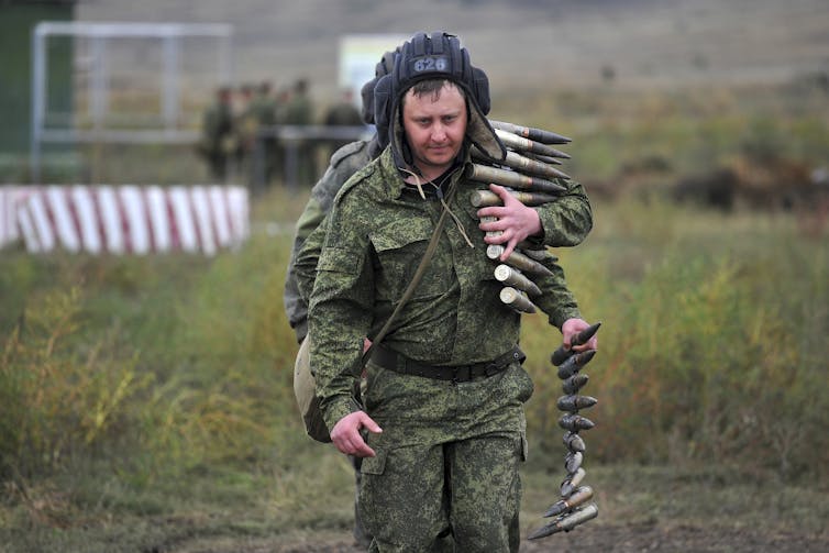 a soldier carrying ammunition