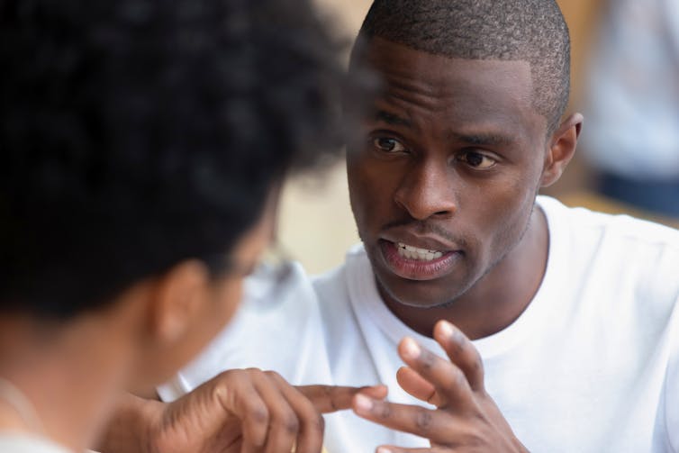 Man is speaking intently to listener