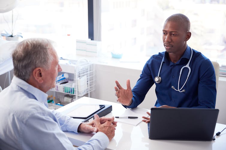 Doctor talks to older patient