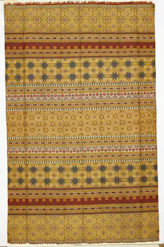 A yellow silk shawl with red and green pattern.