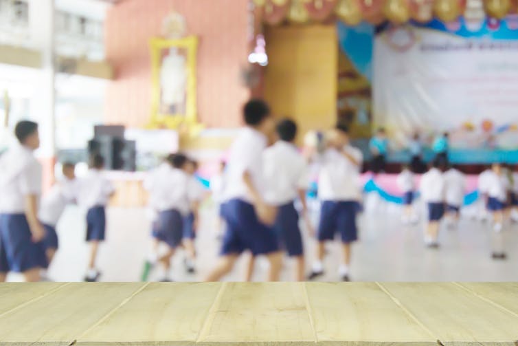 Children play in a school hall.