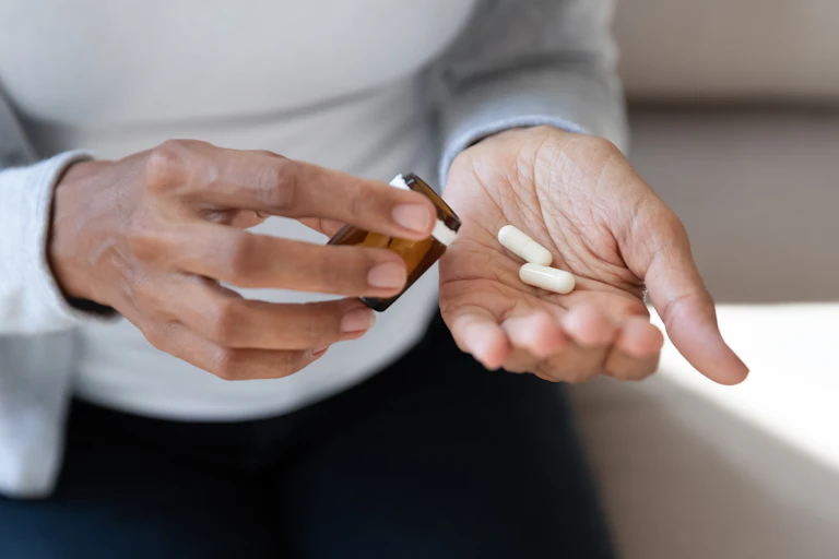 woman's hands hold two pills