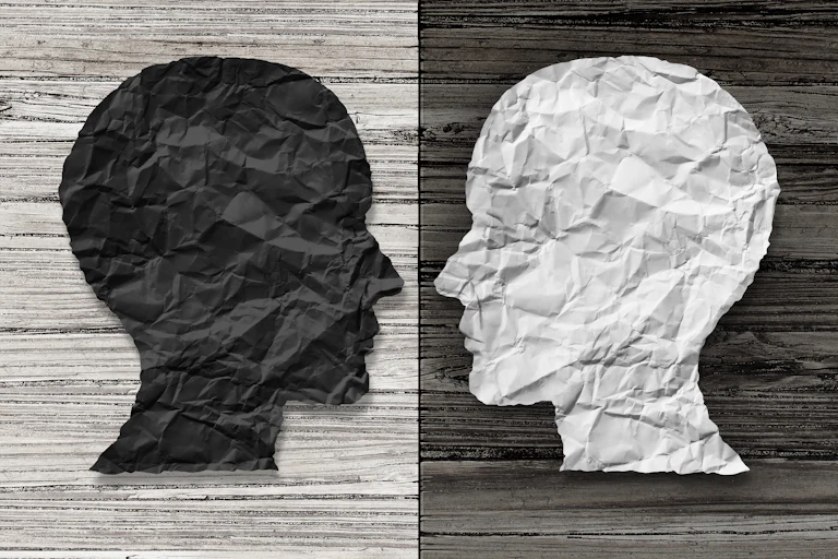 A black and white image of two faces