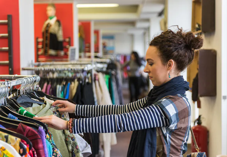 Woman shopping in charity shop.