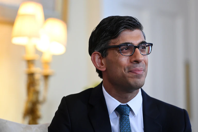 Close up of prime minister Rishi Sunak wearing glasses and looking resolved