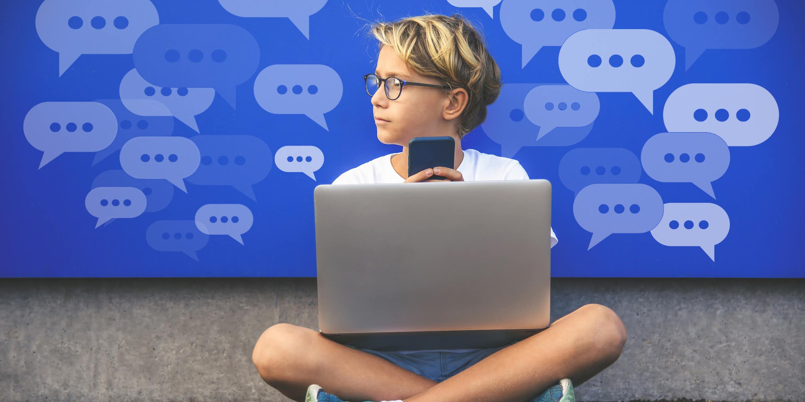 A boy with a laptop and holding a cell phone looks to the left. Conversation bubbles with dots are in the background.