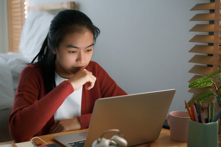 Teenager sitting in front of laptop