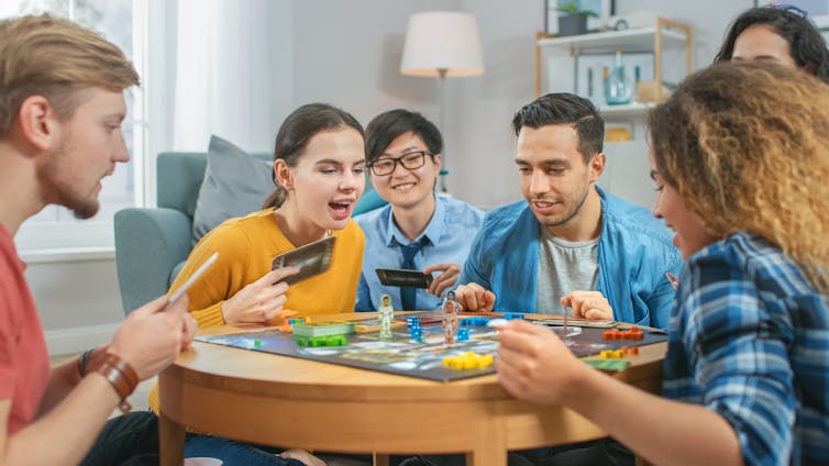 Group of friends playing board game