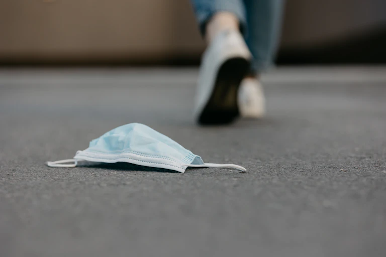 A mask discarded on the ground.