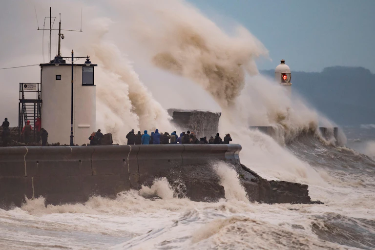 Waves crashing against a wall during a storm.