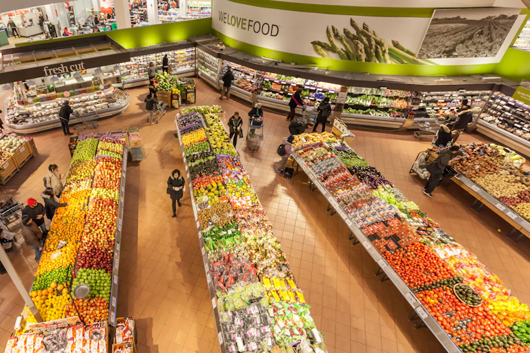 An overhead view of a shoppers in a supermarket stories